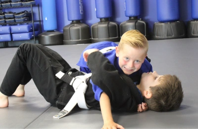 Kids practicing Brazilian Jiu-Jitsu ground drill